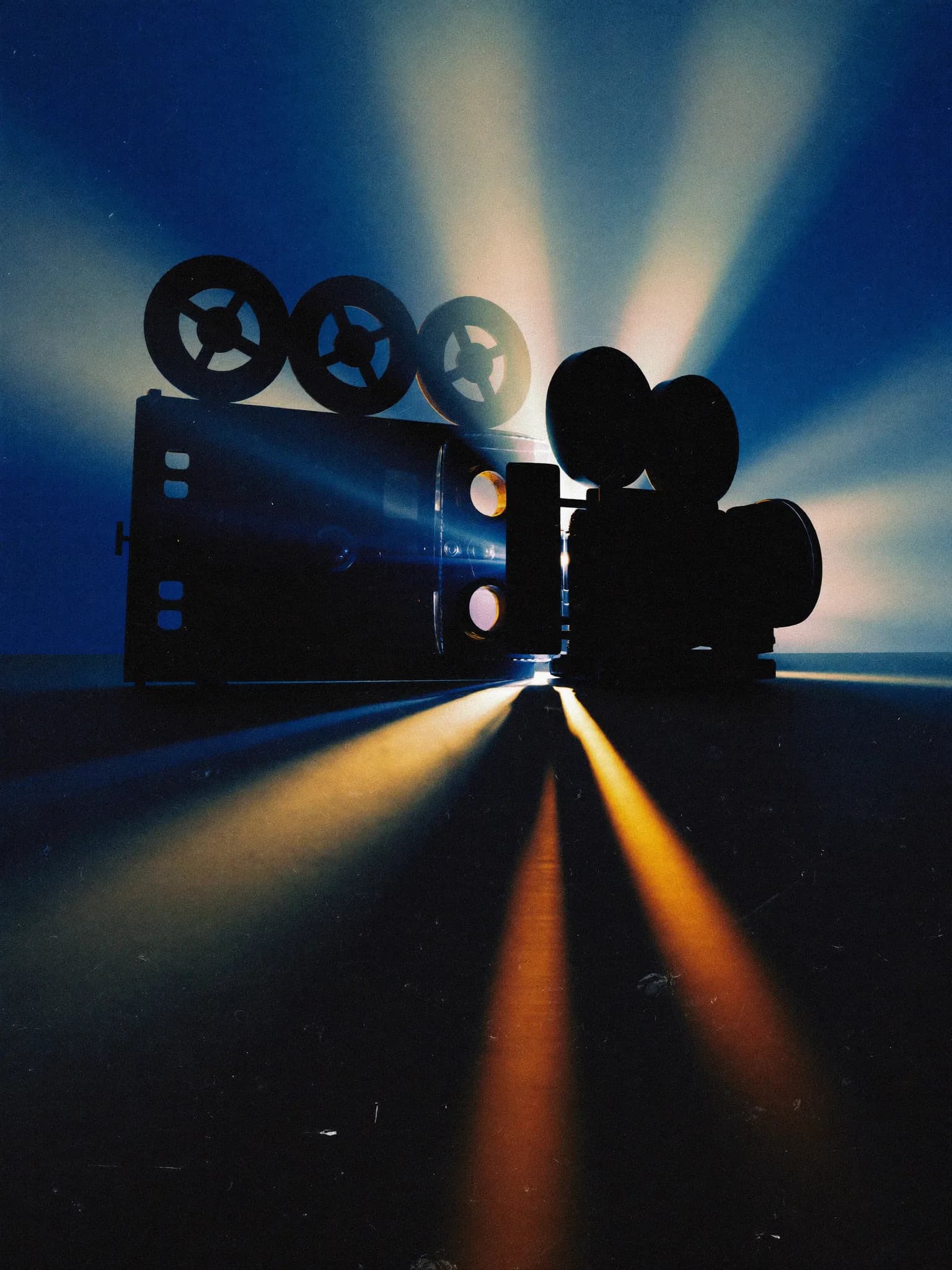 A film projector running, light beams cutting through the dark